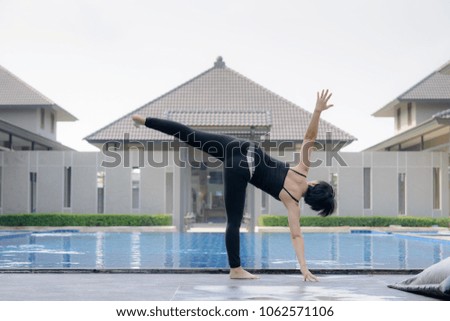 Asian women  practice  Yoga with swimming pool background