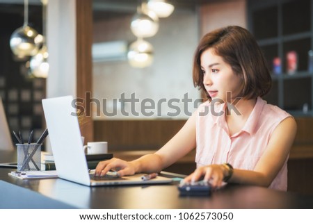 Portrait of beautiful young woman working in the office.