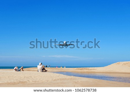 Airplane landing above Beautiful tropical sea with white sand on the beach and clear blue sky people take a photo airplane at phuket thailand image for summer season and travel background