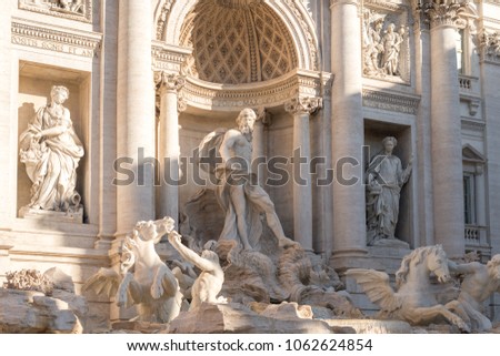 Horizontal picture of beautiful sculptures at Fontana di Trevi during sunrise time, important heritage of Rome, Italy