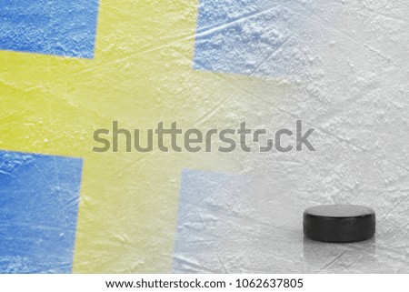 An image of a Swedish flag and on ice and a hockey puck. Concept, hockey