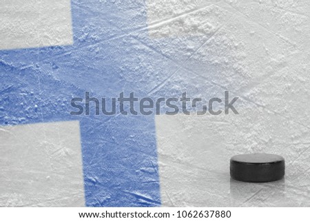 Image of the Finnish flag and on ice and hockey puck. Concept, hockey