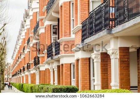 Row of expensive townhouses in Maida Vale, London. An affluent area of northern Paddington close to the Regent Canal and Abbey Road Royalty-Free Stock Photo #1062663284