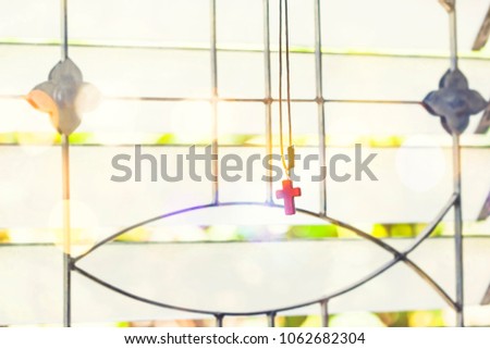 Res cross hang over window with sunlight and bokeh effected, copy space, Christian background