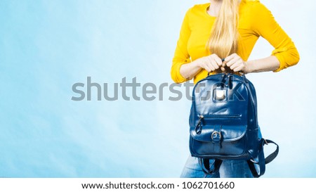 Teenage girl going to school or college wearing stylish backpack. Outfit trendy accessories. On blue