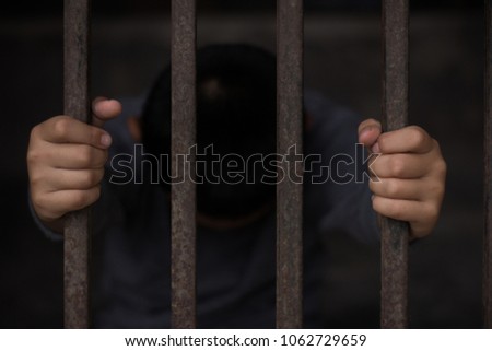 Children are stressed because they are trapped in a steel cage.The concept of violence against children. Royalty-Free Stock Photo #1062729659