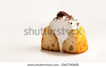 One cupcake  stuffed with white cream  and chocolate topping cut in half, isolated on white background. The image with copy space. 