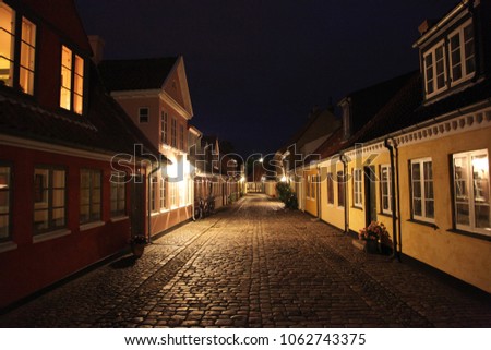 Old fairy tale houses in a centrum of Odense in night Royalty-Free Stock Photo #1062743375
