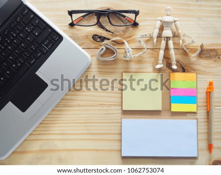 Computer notebook and measuring tape on the table. Meaning of Online Fashion Trading. With a growing online business concept