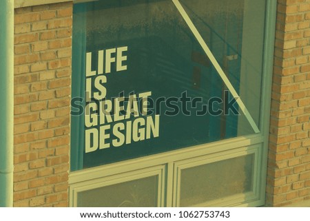 The text"Life is great design" appearing on glass of window