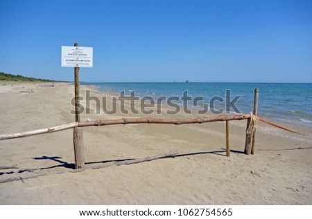 Warning Sign on the beach of the nature reserve at the mouth of the river Bevano, with the inscription: State Forestry Corps. Nature reserve. from 1 April to 15 June: access fee with limitations