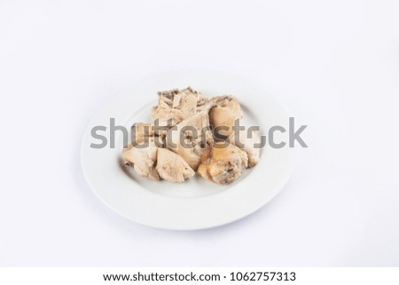 Pieces of boiled chicken are combined in a plate. boiled chicken pieces isolated on white background.
