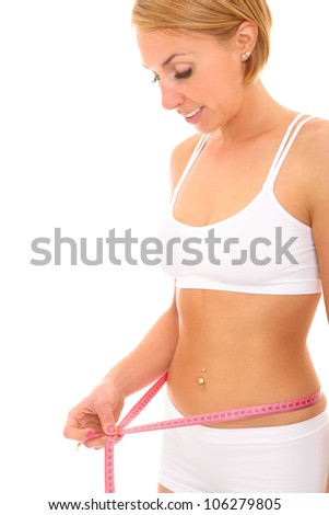 A picture of a young fit woman checking her measurements over white background