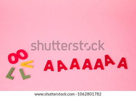 Colorful letters shaped like movie camera on pink background