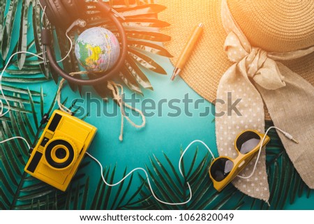 summer concept with travel stuff camera notebook glasses and woman hat flatlay image on color background with free copy space