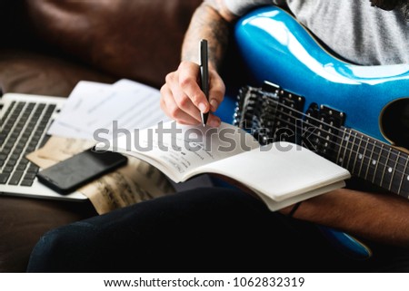 Caucasian man in a songwriting process Royalty-Free Stock Photo #1062832319