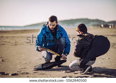 Father and son have fun on beach