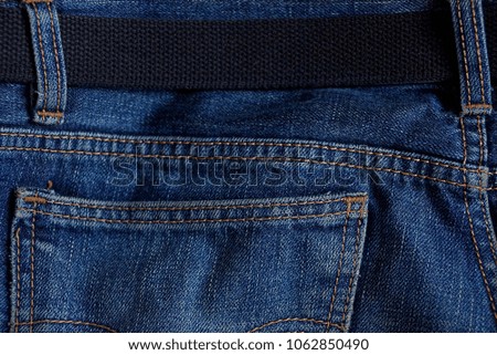 black belt on blue pants with a pocket