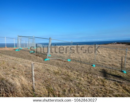Temporary steel metallic fence separating land in a countryside ranch 