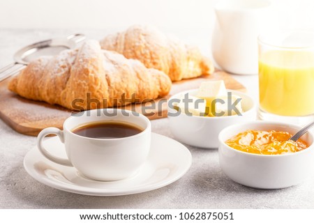 Continental breakfast with fresh croissants, orange juice and coffee, selective focuse. Royalty-Free Stock Photo #1062875051