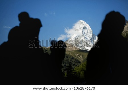 Skiers looking at Zermatt Matterhorn in Silhouette