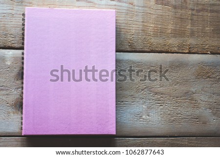 Closeup notebook on wooden table.