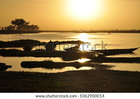 Silhouettes of people along Niger river 