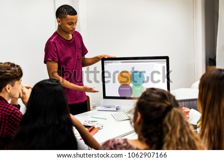Young boy presenting a project to the team