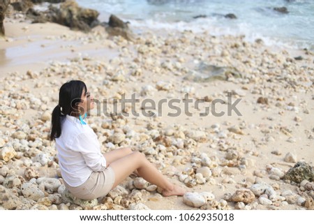woman beach beauty enjoy holiday. Young asian female enjoying sunny day with sitting on tropical beach.