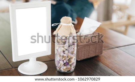 Blank placard to insert text in the tableware advertising with a flowerpot on the side.