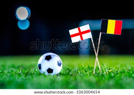 England - Belgium, Group G, Thursday, 28. June, Football, National Flags on green grass, white football ball on ground. Royalty-Free Stock Photo #1063004654