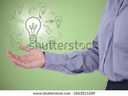 Business woman mid section with lightbulb doodles and flare in hand against green background