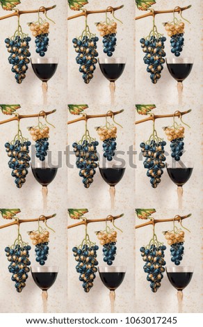 assemblage with mosaic effect of red  wine on a decorative background, background with grape cluster decorated, front view
