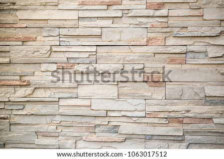 The stone wall texture background natural color.Background of stone wall texture photo.Natural stone wall texture for background.Old Brick texture, Grunge brick wall background.