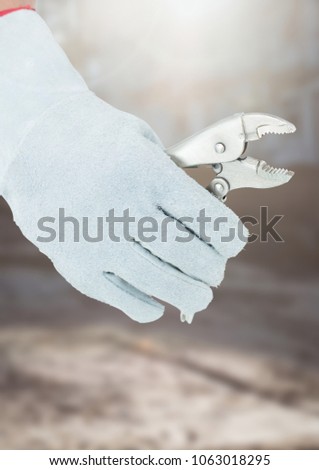 Hand with plier on building site