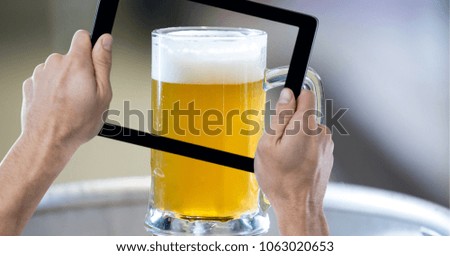 Hand taking picture of beer glass