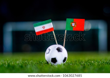IR Iran - Portugal, Group B, Monday, 25. June, Football, National Flags on green grass, white football ball on ground. Royalty-Free Stock Photo #1063027685