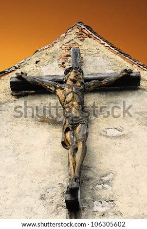 Beautiful wood cross with jesus crucifixion,on a yellow background, ideal for easter or christmas
