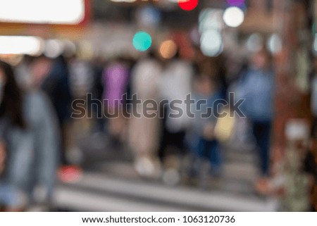 Blurred bokeh of crowd of people walking in the city