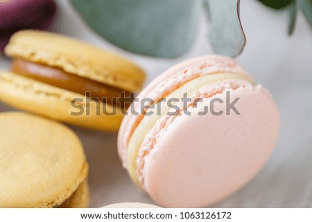 Close-up colorful French or Italian macaron on white wooden table. Macarons is French dessert served with tea or coffee. wallpaper, Horizontal photo