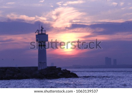 Istanbul city's lighthouse, sea and sunset. Silhouette city with beautiful landscape.