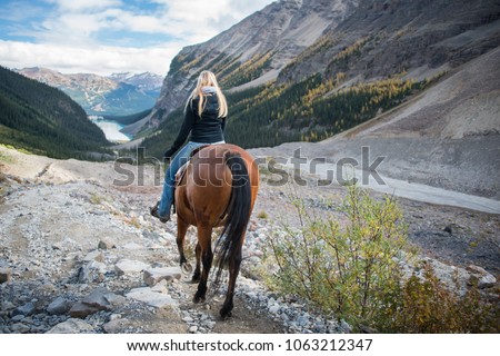 Horseback riding in Lake Louise, Banff National Park, Canadian Rockies Royalty-Free Stock Photo #1063212347