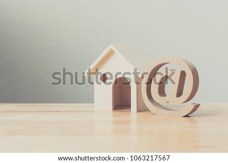 Wooden house and address sign on wood table. Email contact us concept