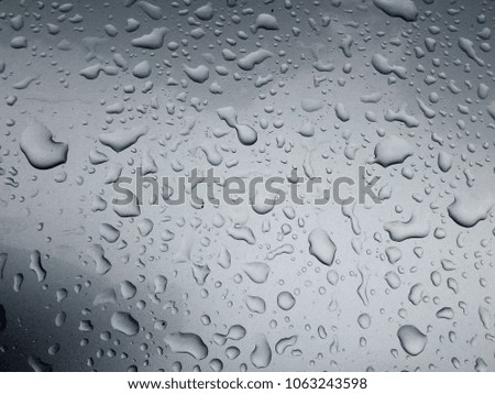 Drops on the Surface of the Car or on the Iron Surface Flow Down. Abstract Background and Water Texture for Design.