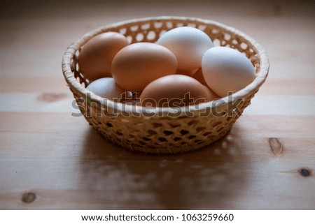 Fresh eggs of the two species from beige and white shell. Rustic still life.
