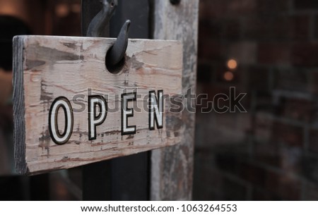 Wooden signs with the letters "open" can be used to engage the media to do business.
