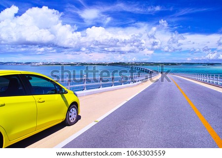 Miyakojima in summer. A car parked in the parking space of Irabu Ohashi and a view of Miyakojima direction Royalty-Free Stock Photo #1063303559