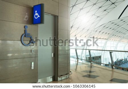 In front of public toilet or public restoom for men an weman disabled people with disabled sign light box in international airport. Disabled toilet concept.