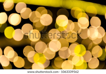 Yellow gold lights, garlands. Blurred photo. Celebratory background.