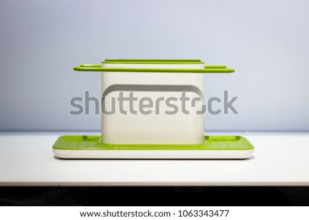empty green soap holde on white shelf